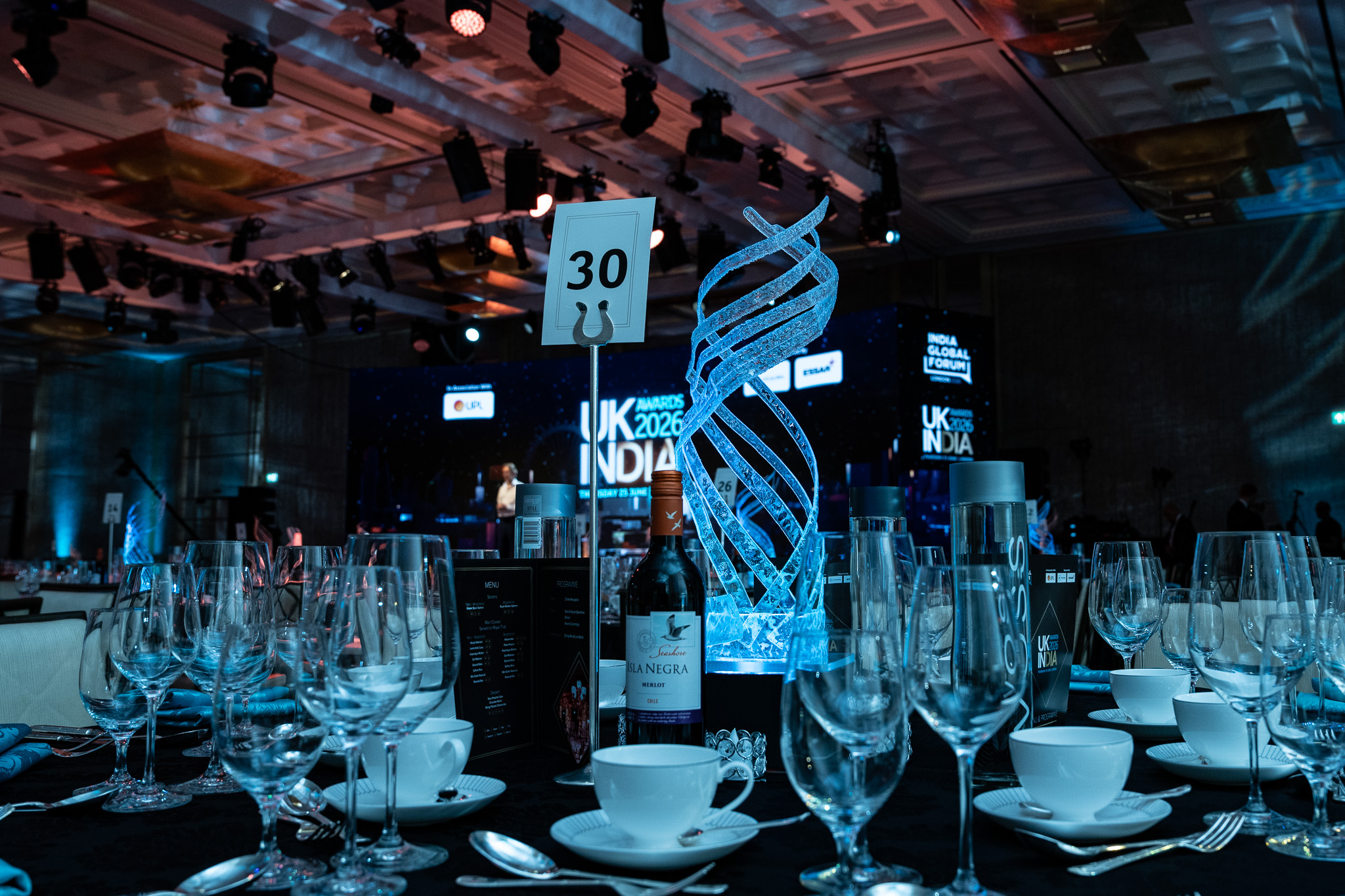UK-India Awards 2026 at The Peninsula London — table detail with a branded centrepiece, by Kudos AV