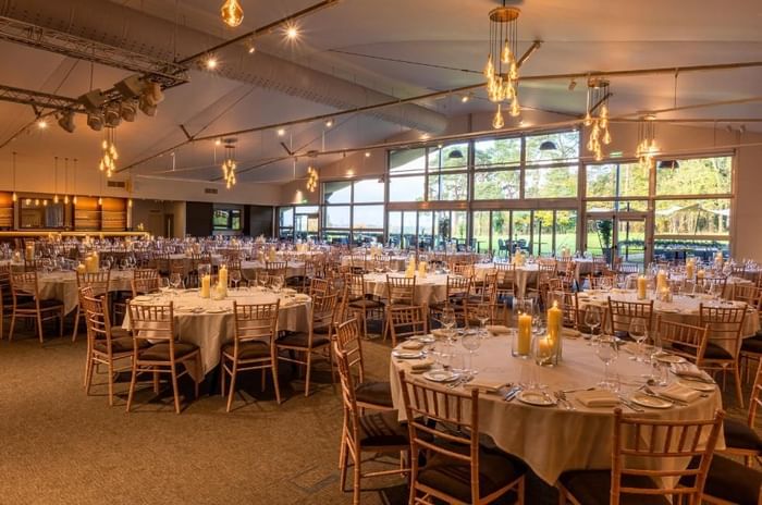 The King Suite set for a banquet with round tables and views over the Berkshire grounds